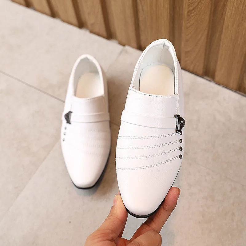 Boys black leather British style shoes with white accents, casual performance shoes for children, shown from side view.