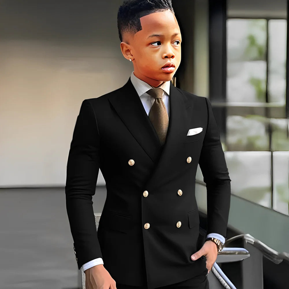 Navy blue solid boy's tuxedo with peak lapel, double-breasted jacket and matching trousers, stylish for formal events and weddings.