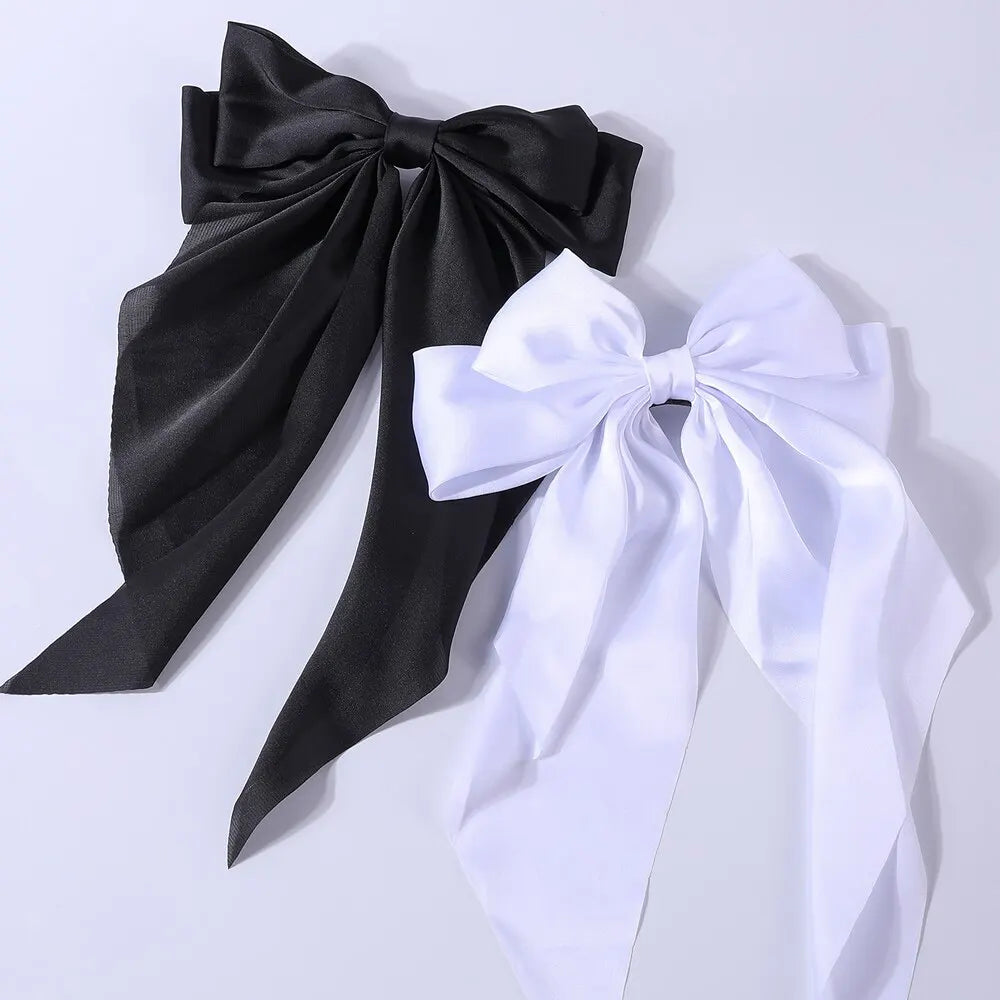 Set of two elegant satin bow ribbon hair clips for women, featuring solid bowknot design and secure hairpin barrettes for girls and women.