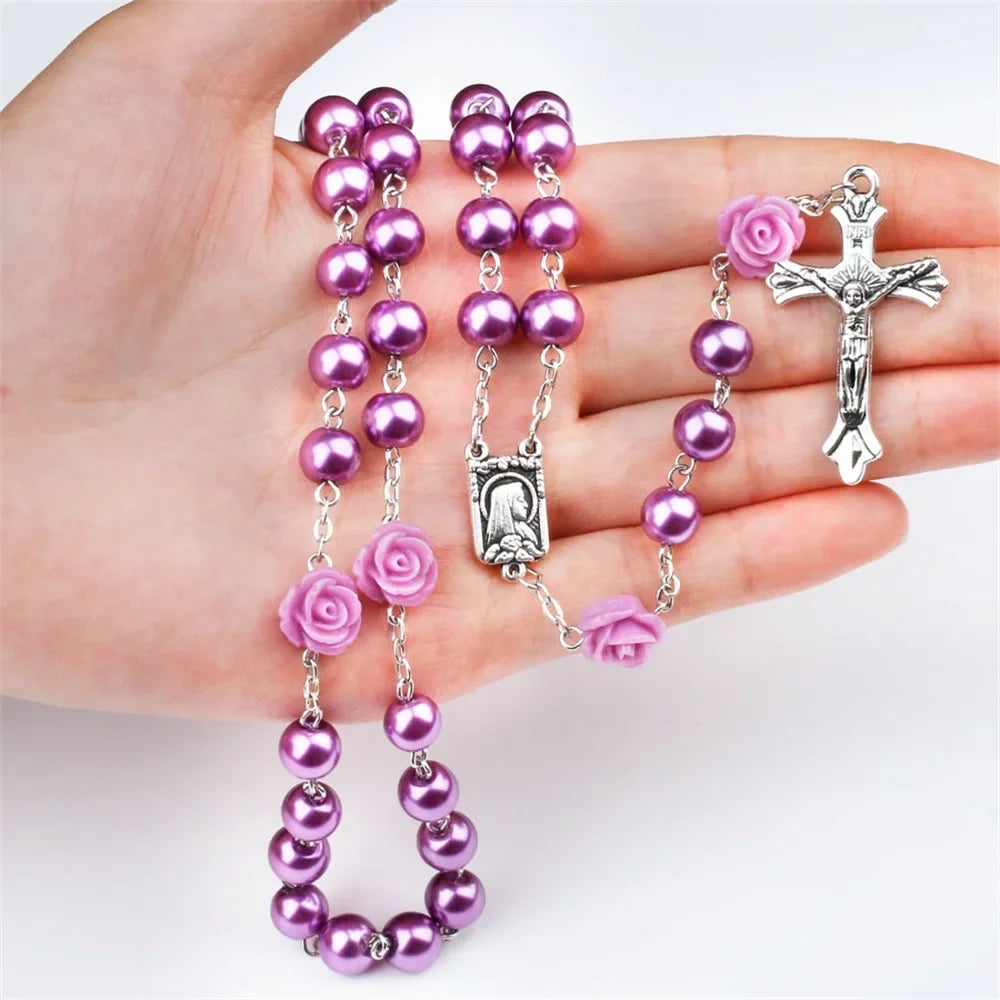 Pink rosary necklace for women with rose glass beads, crucifix cross pendant, and INRI inscription, featuring a long chain.