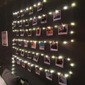 LED photo clip string lights by Showlu Smart General with clips and warm white LED bulbs hanging on a wall.