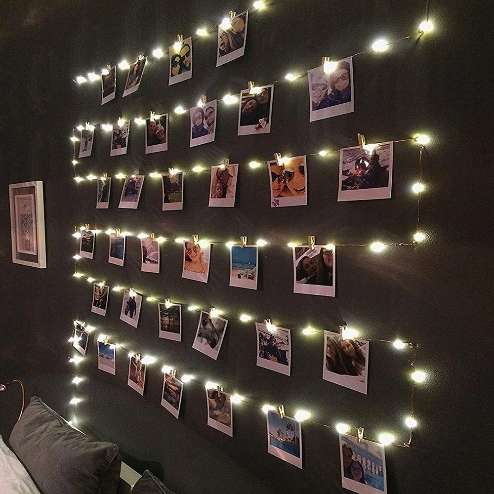 LED photo clip string lights by Showlu Smart General with clips and warm white LED bulbs hanging on a wall.