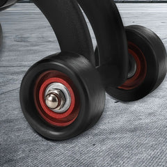 A close-up view of the black rubber wheels and red hubs on a four-wheeled abdominal exercise roller.