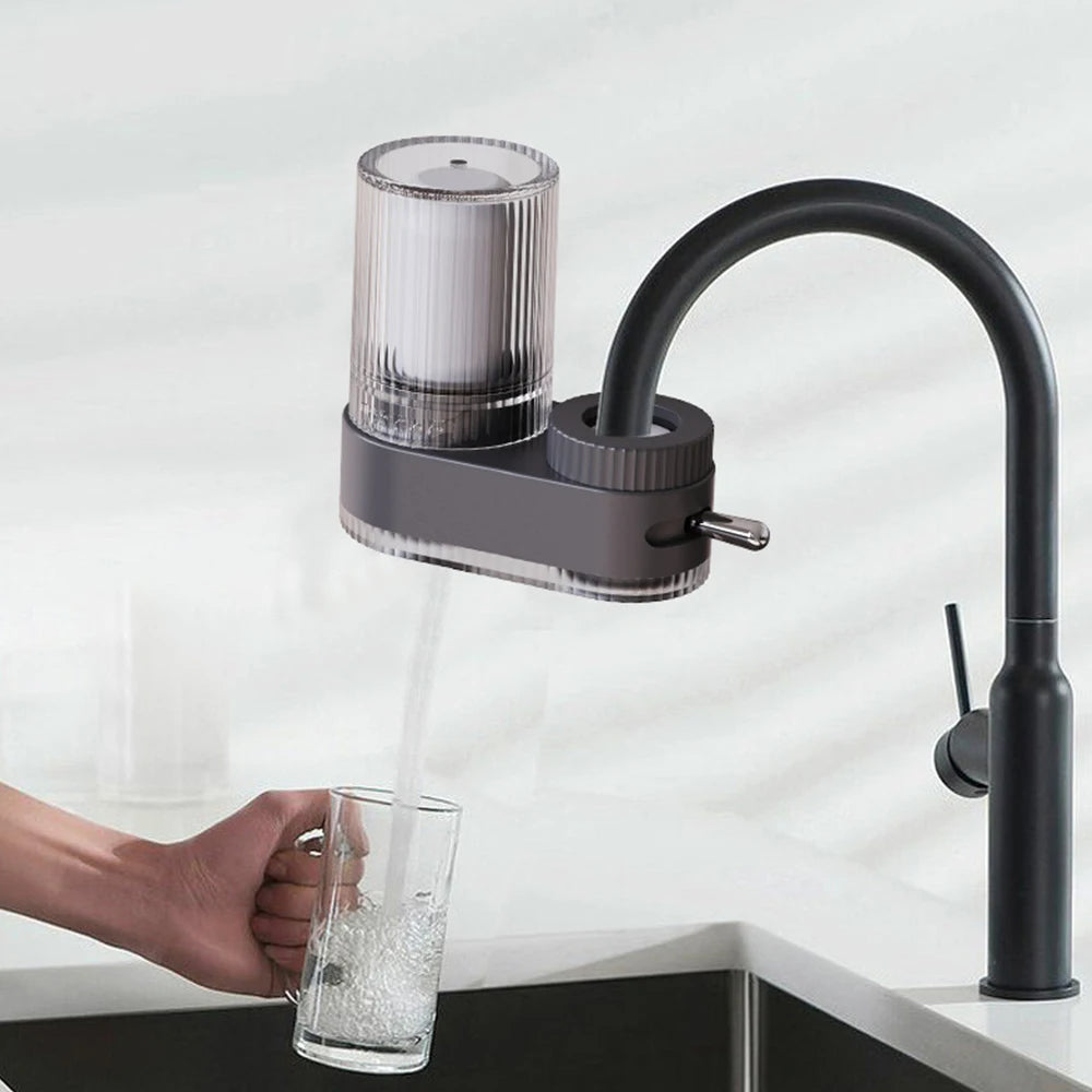 Showlu Universal Faucet Water Purifier with washable ceramic filter element attached to a kitchen sink faucet.