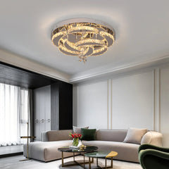 A modern flush mount ceiling light featuring layered, swirling rings of K9 crystal.