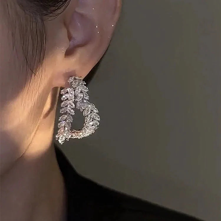 DINGABIYU zircon flower stud earrings with crystal leaf design, luxury jewelry featuring sparkling stones and intricate details.