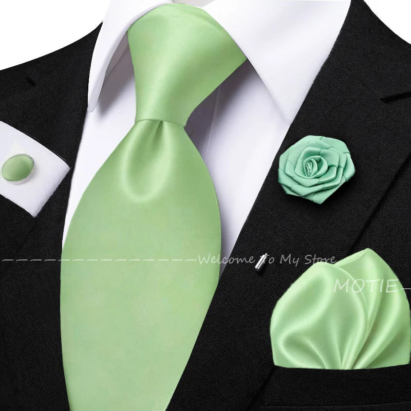 Men's solid green tie set with pocket square, flower brooch, cufflinks, and collar accessories for wedding or daily wear.