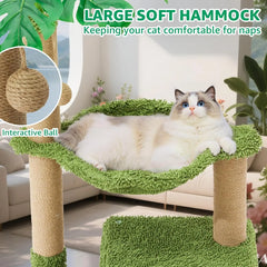 A fluffy white cat rests in a green hammock on a cat tree with sisal scratching posts.