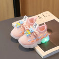 Unisex luminous LED sneakers for kids by Showlu Fashion, featuring PU leather construction and glowing soles.