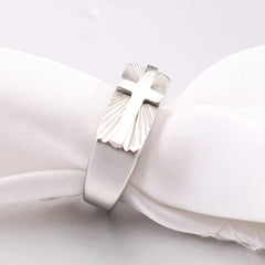 A silver-toned stainless steel men's ring featuring a cross set against a sunburst pattern.