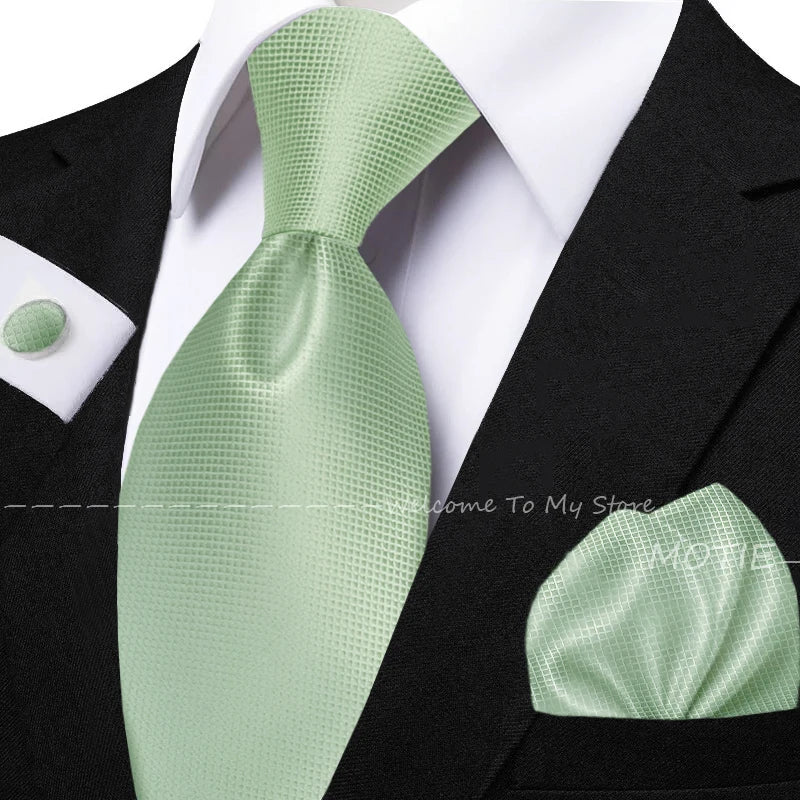 Men's sage green tie set with pocket square, flower brooch, cufflinks, and collar accessory for daily wear or wedding groom style.