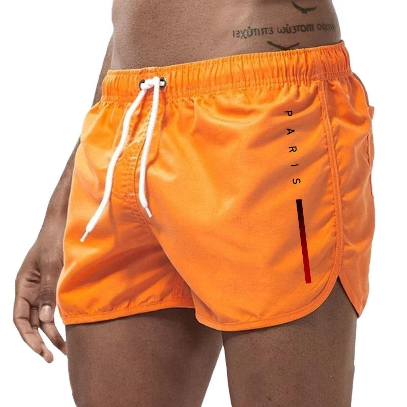Men's casual board shorts in blue, designed for summer beach activities, sports, and fitness, featuring a comfortable fit and stylish look.