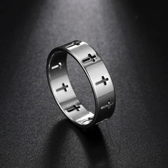 A silver-colored stainless steel ring featuring a repeating cutout cross pattern.