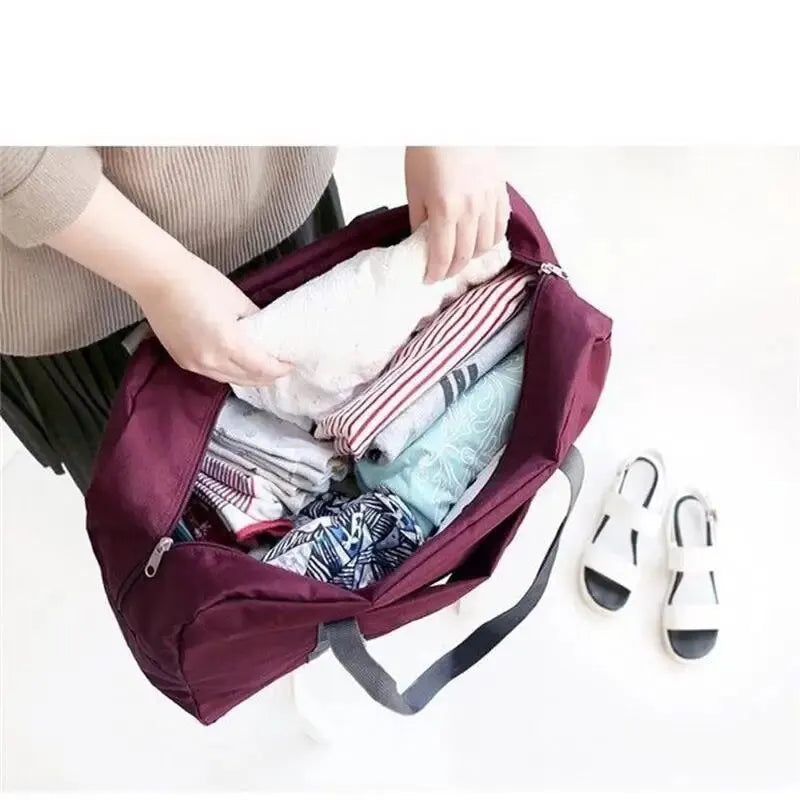 Red, navy, and green multifunctional folding travel bag with single shoulder strap, waterproof, large capacity luggage storage.