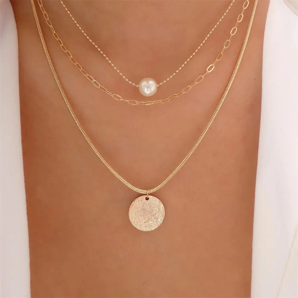 Elegant vintage pearl pendant necklace for women, featuring a multi-layer gold chain choker with classic round pearl charm.