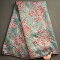 Nigerian Damask tulle fabric featuring floral brocade jacquard lace in vibrant colors, suitable for traditional and elegant garments