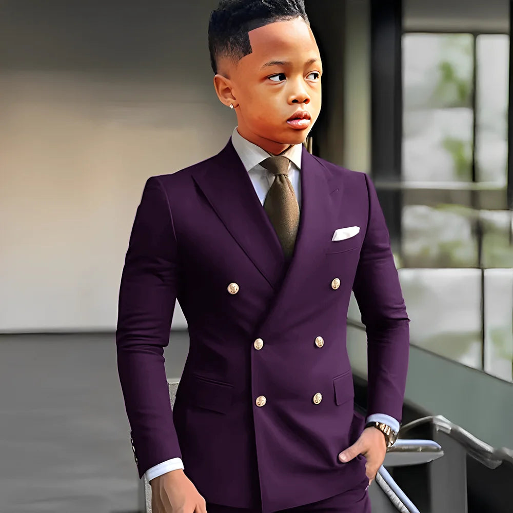 Navy blue solid boy's tuxedo with peak lapel, double-breasted two-piece suit for formal occasions and weddings, by Showlu Fashion.