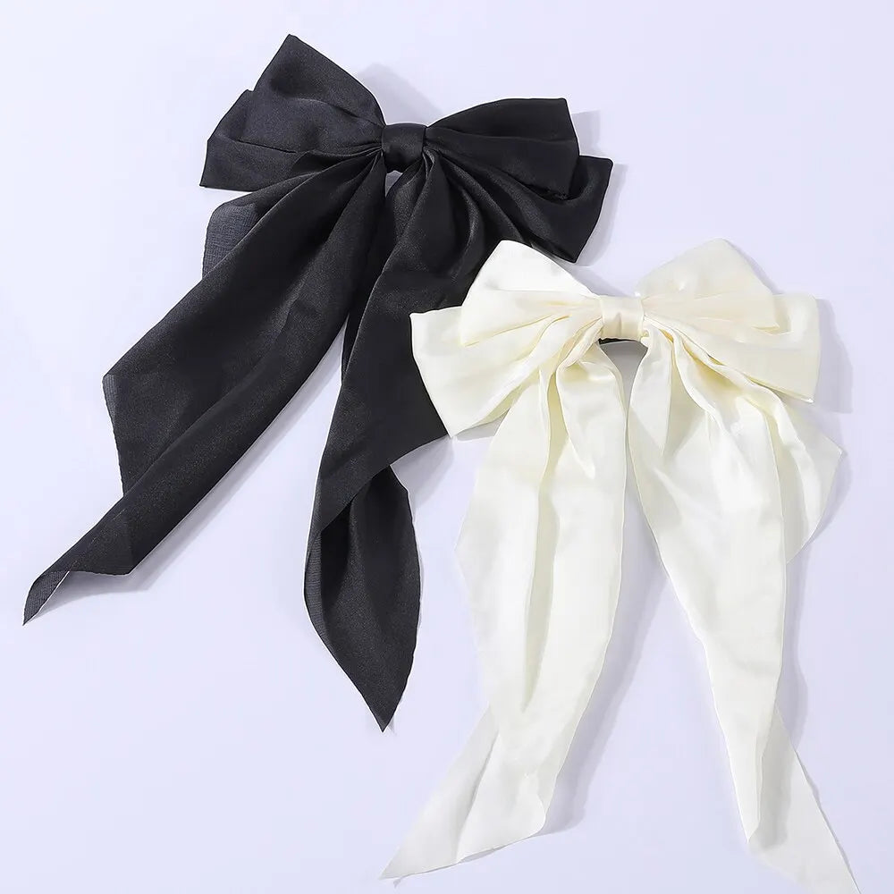 Set of two elegant satin bow ribbon hair clips for women and girls, perfect for ponytails and hair accessories.