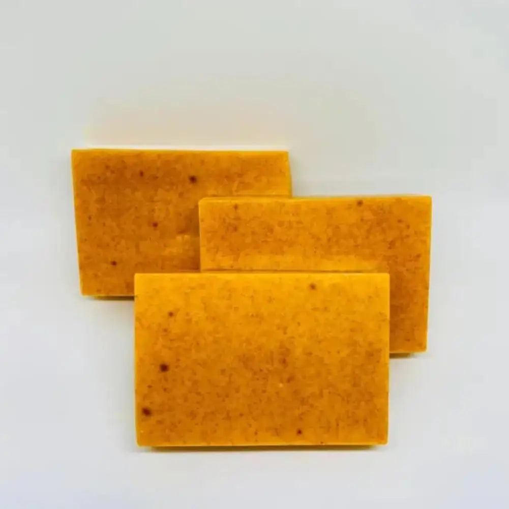 Handmade turmeric and lemon kojic acid soap bar, natural body and facial cleanser, shown in a 100g size.