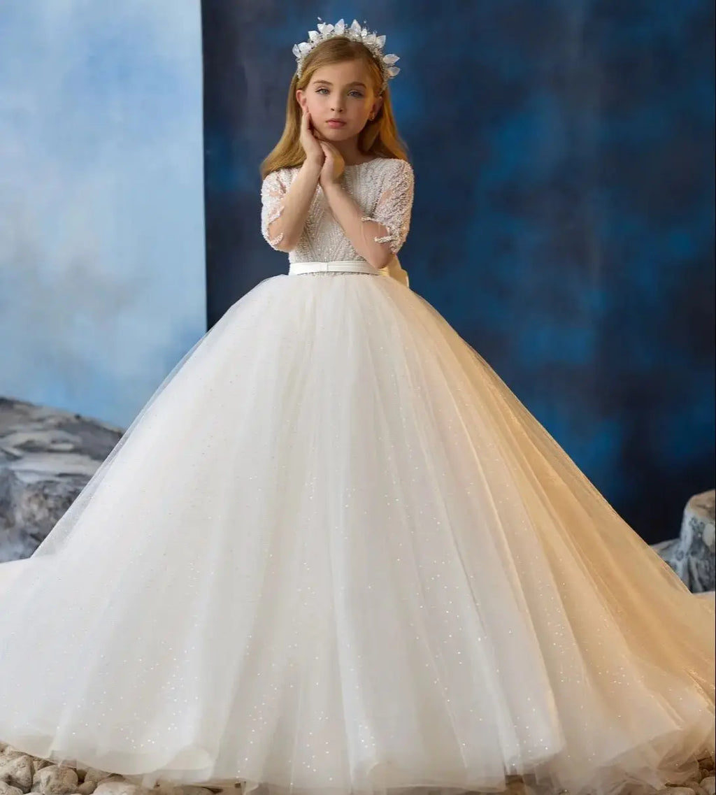 Ivory flower girl dress by Showlu Fashion with beaded bow, long sleeves, ideal for weddings and first communions.