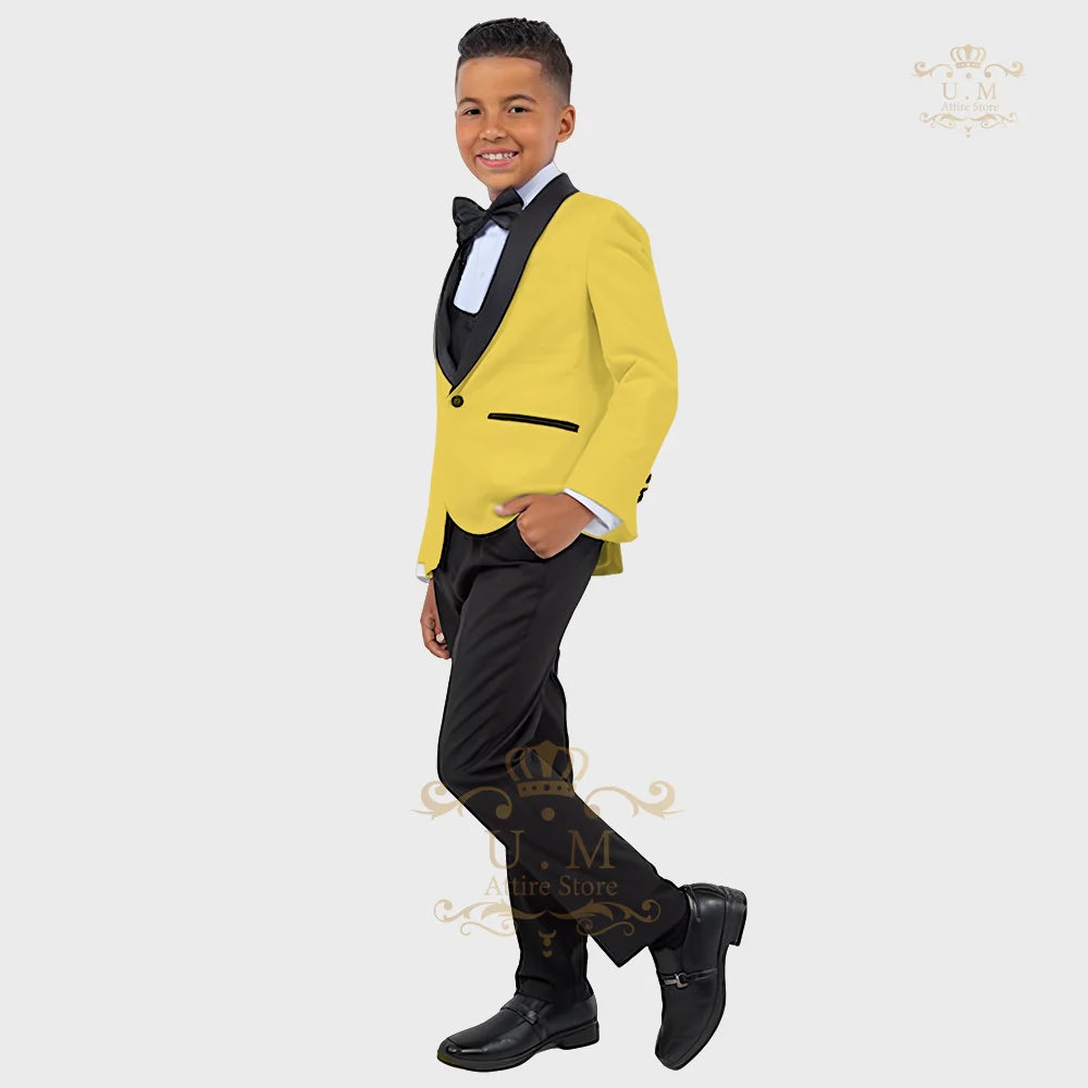 Boy wearing a white tuxedo jacket, vest, and pants from SHOWLU FASHION STORE's ZHIO Boys' 3-Piece Formal Suit.