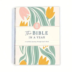 A spiral-bound Bible study journal with a floral cover titled The Bible In A Year.