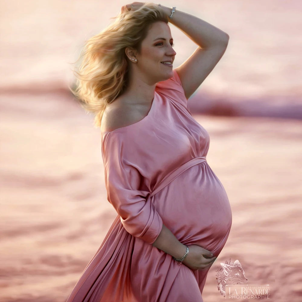 Showlu Maternity chiffon cape made of soft tulle, perfect for photo shoots, draped over a pregnant woman in a serene setting.