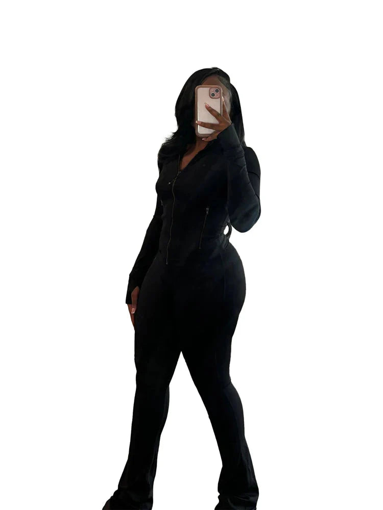 JENYAGE Women's two-piece tracksuit with flared pants and zip-up top, shown in black on a model, casual athletic style.