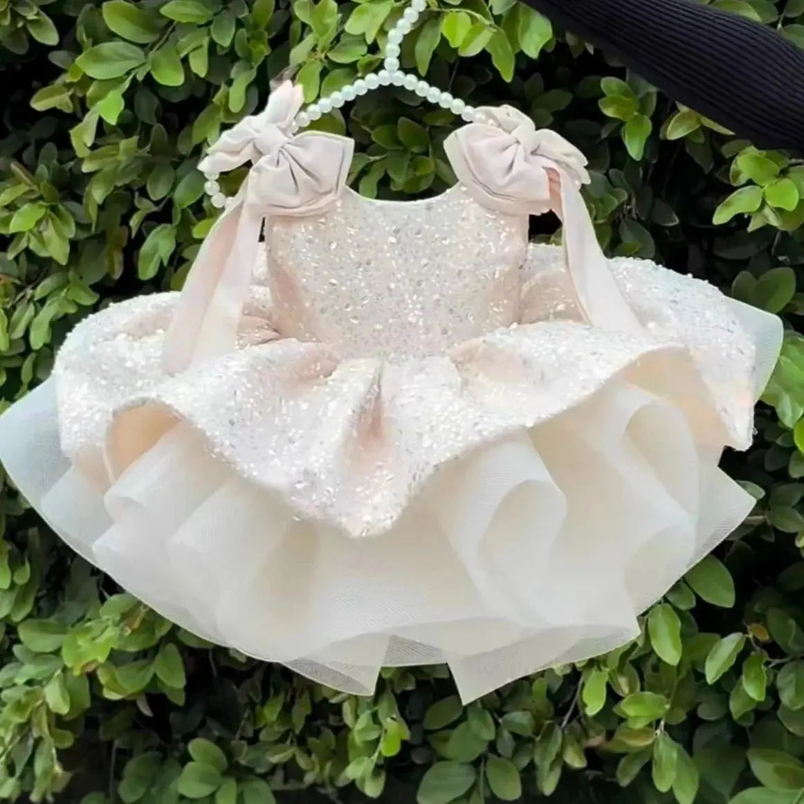 Pink flower girl dress by Showlu Smart General with sleeveless design, bow, sequins, puffy skirt, perfect for weddings and parties.