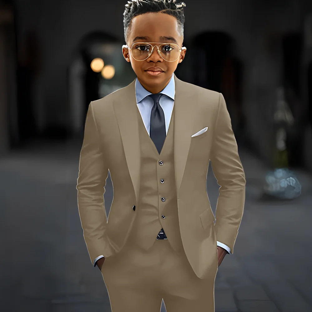 Dark grey boys' 3-piece suit with slim fit, single-breasted jacket, peak lapel, and matching pants and vest, stylish kids' formal set
