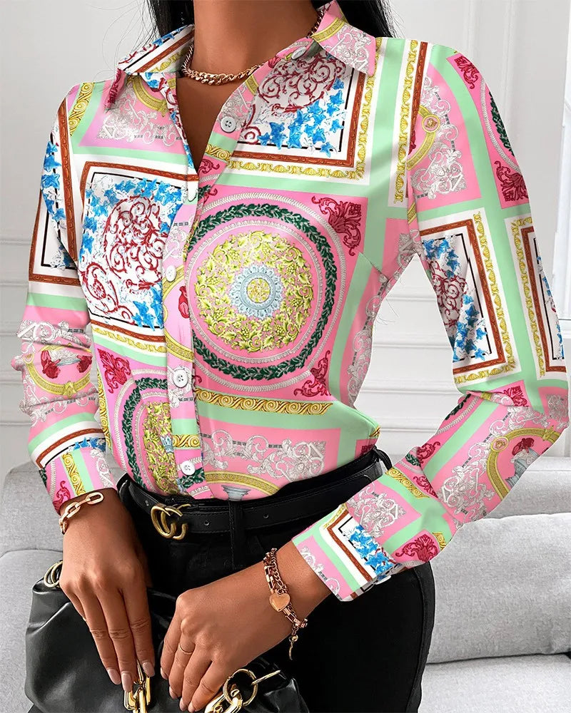 Women's long sleeve blouse with floral, letter, and geometric square print, featuring a turn-down collar and chain details.