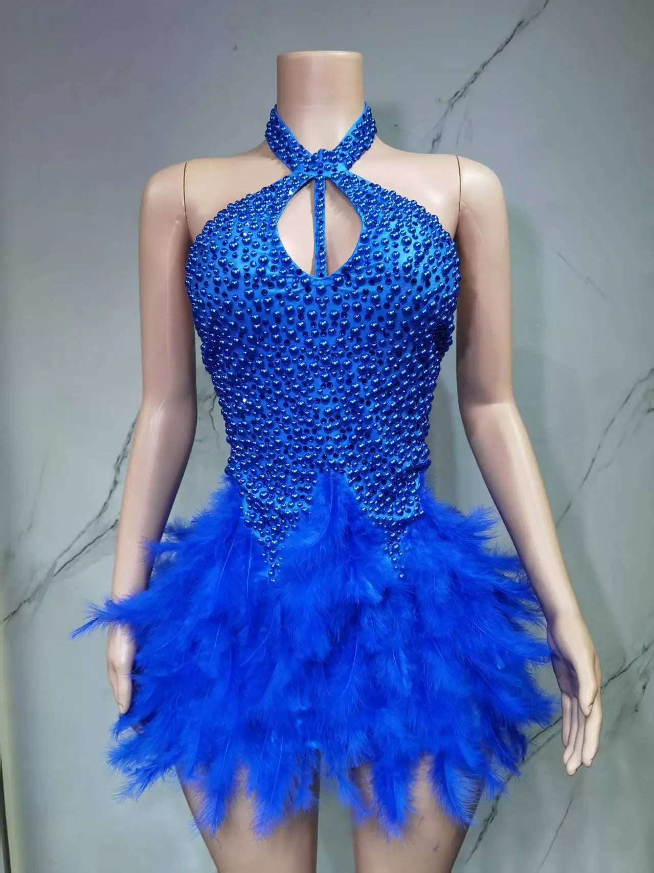 Sexy Latin dance dress by Showlu Fashion with airy hollow design and feather skirt hanging neck for stylish movement.