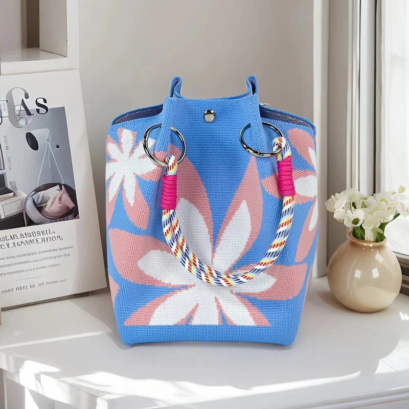 Women's vintage floral knit tote bag with adjustable straps, metal rings, and snap closure, perfect for casual travel and storage.