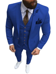 A man wears a slim-fit royal blue three-piece suit with a white shirt and brown tie.