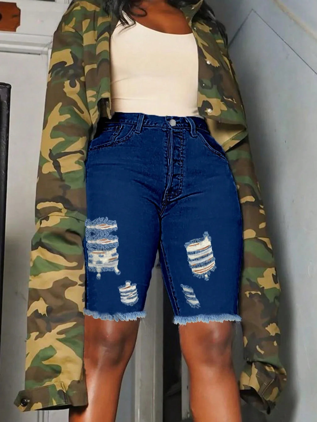 Slim-fit women's denim Bermuda shorts by SHOWLU with ripped, frayed hem, casual summer style, dark wash, and distressed details.