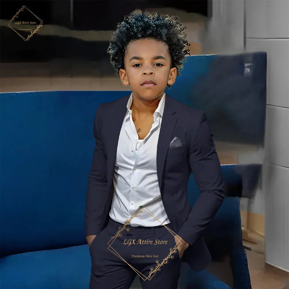 Boy wearing an orange slim fit 2-piece suit by SHOWLU FASHION STORE, featuring a single-breasted twill jacket and matching pants.