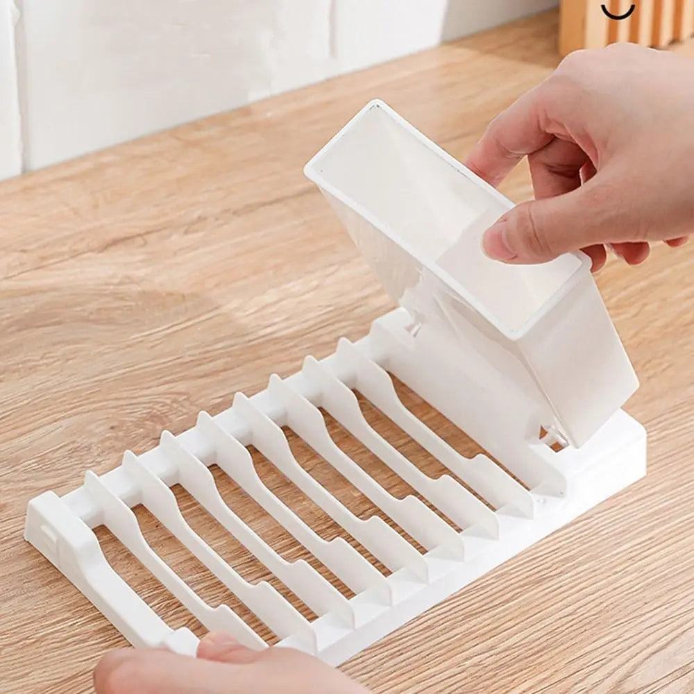 Foldable dish drying rack by Showlu Smart General, showing a compact, metal kitchen rack with foldable arms for drying dishes.