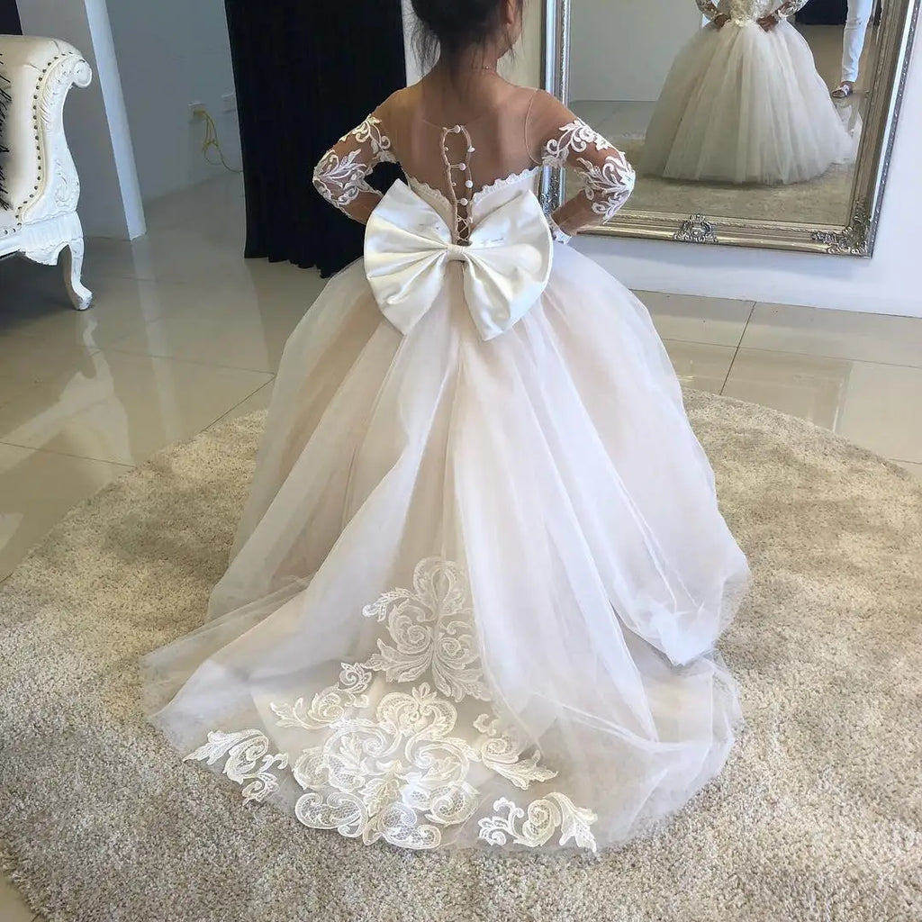 White lace flower girl dress by Showlu Fashion Store featuring long sleeves, tulle ball gown style for special occasions.