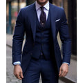 Navy blue 3-piece slim fit men's suit with notched lapel tuxedo, displayed on a hanger, showcasing stylish formal attire.