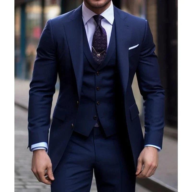 Navy blue 3-piece slim fit men's suit with notched lapel tuxedo, displayed on a hanger, showcasing stylish formal attire.