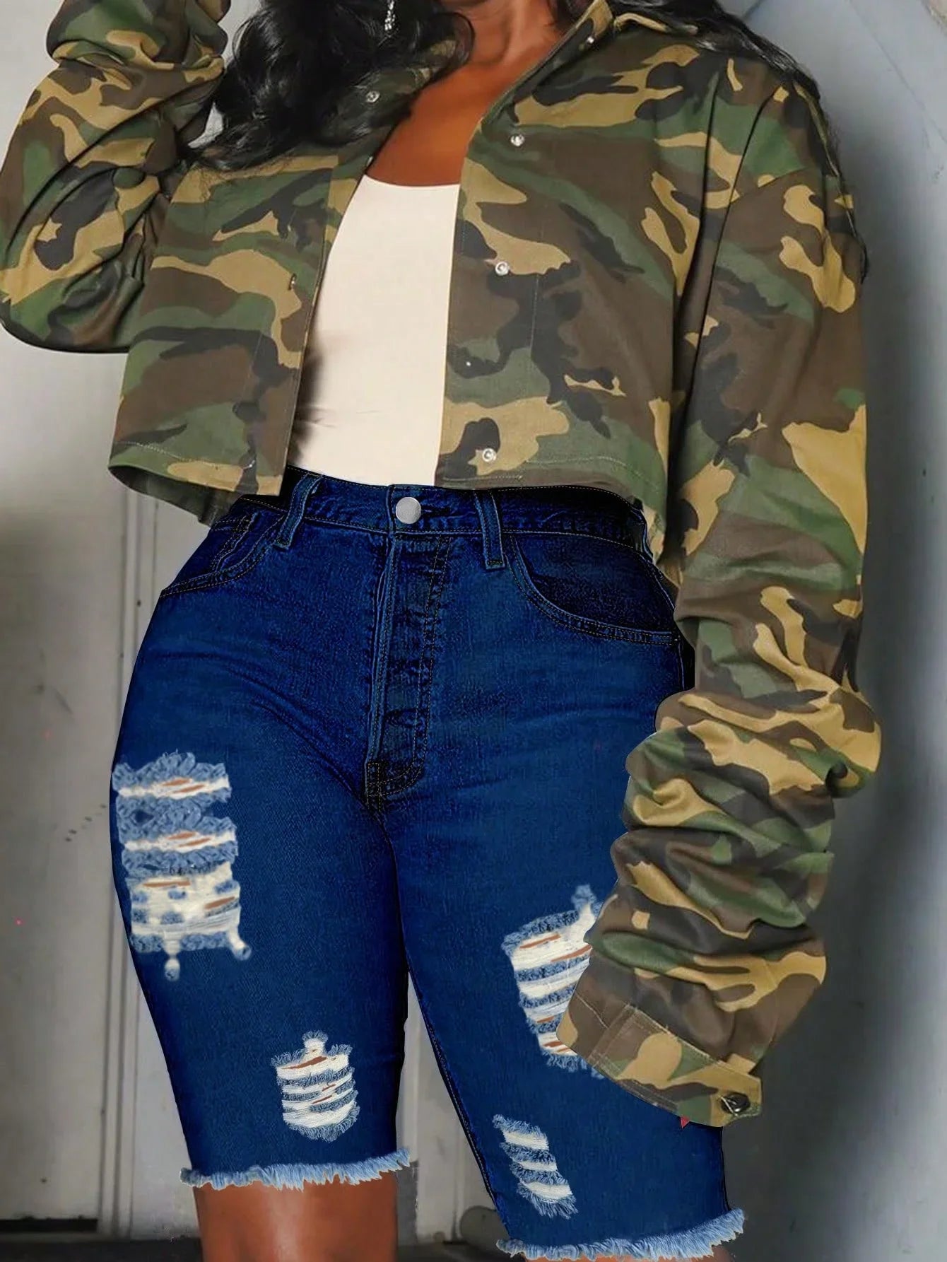 Slim-fit women's denim Bermuda shorts with ripped, frayed hem from SHOWLU FASHION STORE, displayed on a neutral background.