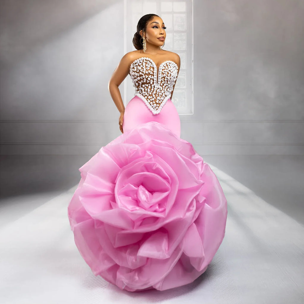 Elegant African wedding prom dress by Showlu Fashion with large floral design, pearls, beads, and rose accents.