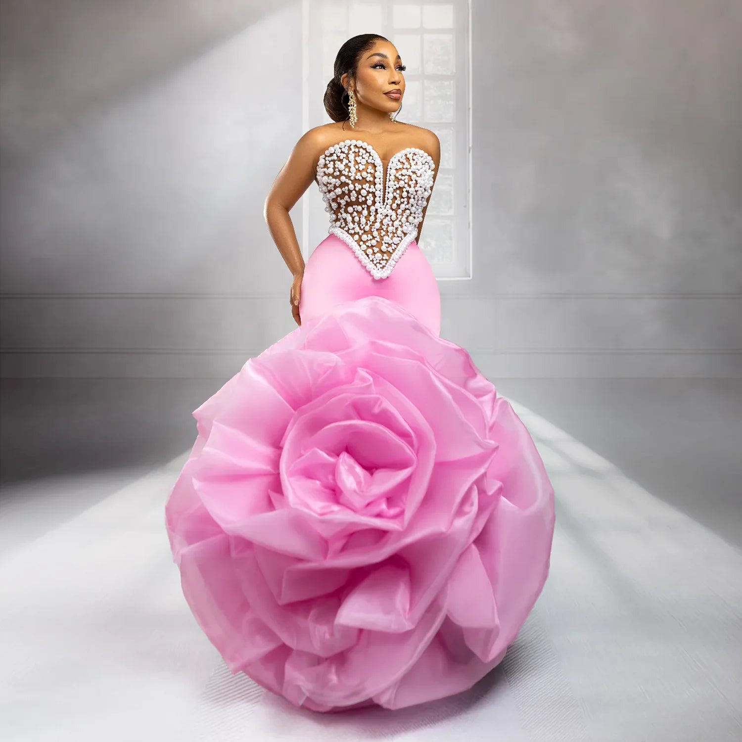 Elegant African wedding prom dress by Showlu Fashion with large floral design, pearls, beads, and rose accents.