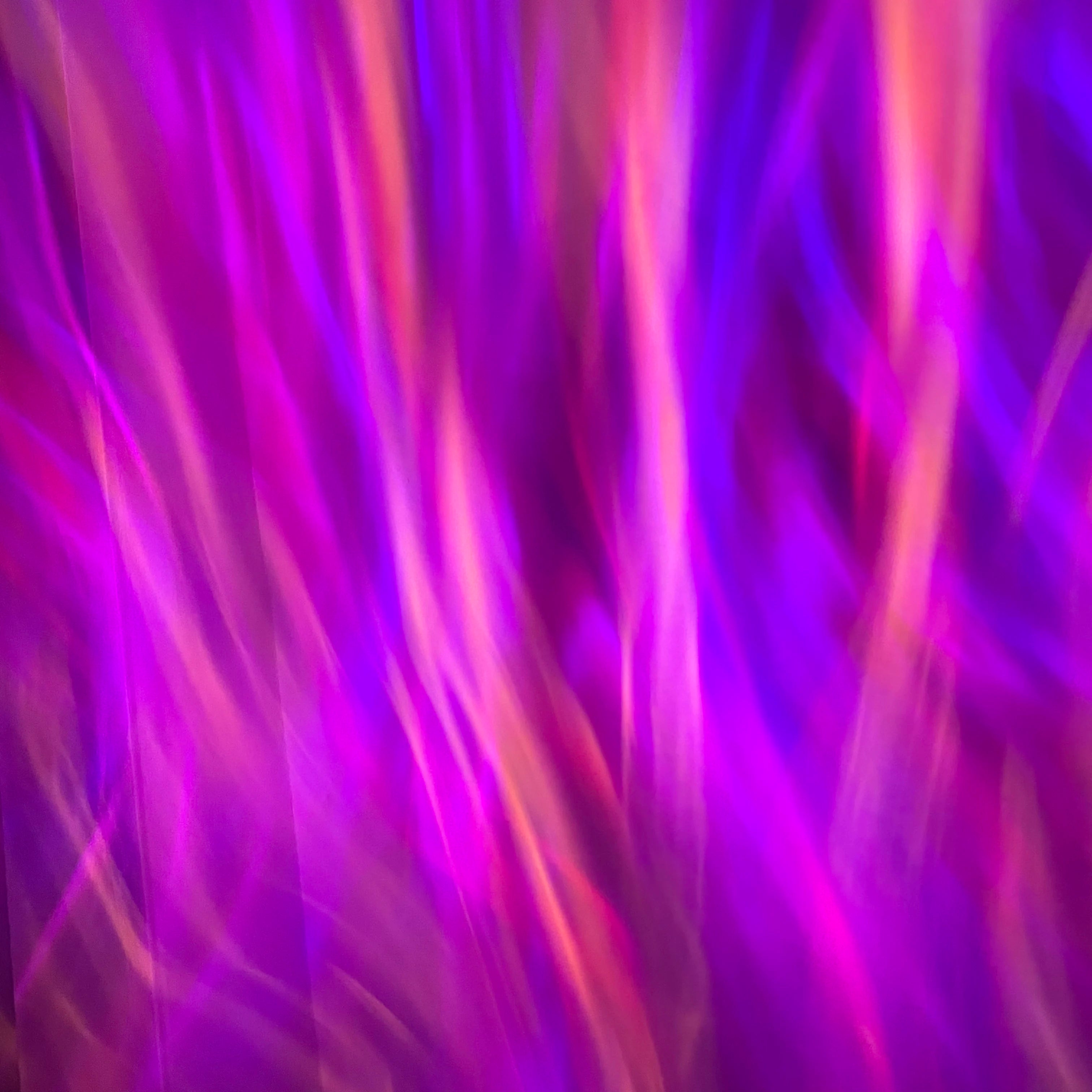 Showlu Smart General Aurora Borealis Projector displaying vibrant green and purple northern lights on a wall.