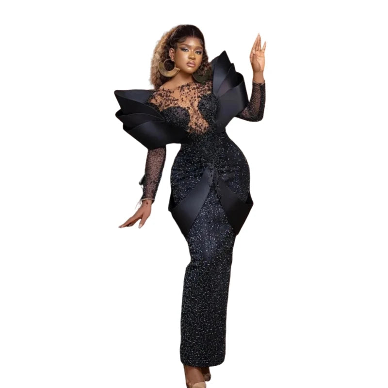 Elegant black African formal prom dress with beading, pearls, and long sleeves, designed for women’s evening and party wear.
