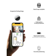 A hand holds a smartphone displaying a tracking app next to a small circular GPS tracker.