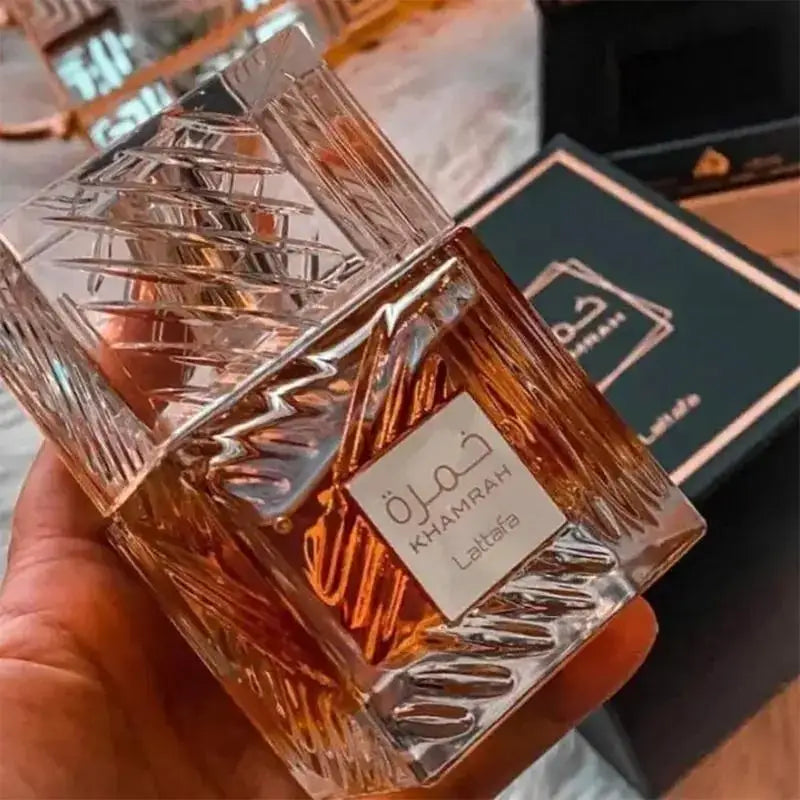 Unisex perfume spray by Lattafa Khamrah featuring warm vanilla and cinnamon scents in a 100ml bottle.