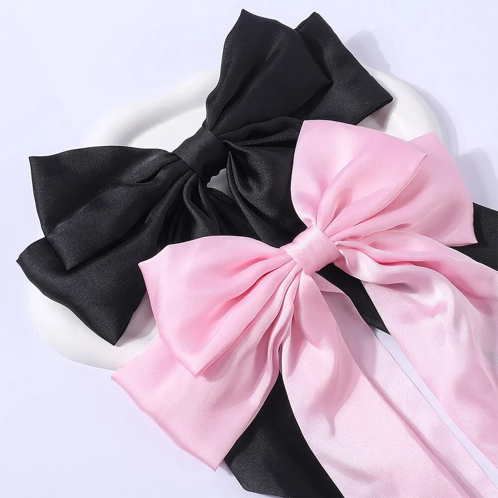 Two elegant satin bow hair clips for women and girls, featuring solid bowknot design for ponytails and hair styling.