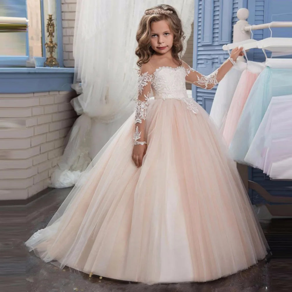 Light pink flower girl dress by Showlu Fashion with tulle, white appliques, long sleeves, ideal for weddings and special occasions.