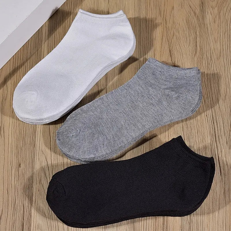 Five pairs of Showlu Fashion low cut boat socks for women and men, breathable, anti-slip, no show ankle sock in solid colors.